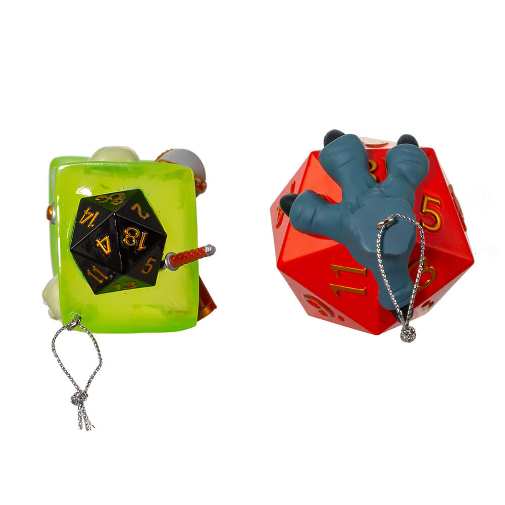 Dungeons & Dragons ornament set featuring a green gelatinous cube with items like skull, treasure chest, sword, etc inside. Second ornament is a red twenty sided dice held by a grey three-toed claw. Top view shows black dice in cube.