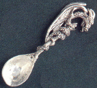pewter spoon with dragon on the handle and tail wrapped around the handle