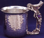 hammered pewter cup with fairy looking in and same fairy as the handle inlayed with gems.