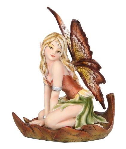 A blond fairy with a brown and green flower dress and tan wings sits in a leaf boat