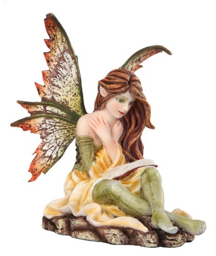 Pixie with brown hair and a green and yellow outfit sits reading a book. The fairy has brown and green speckled wings