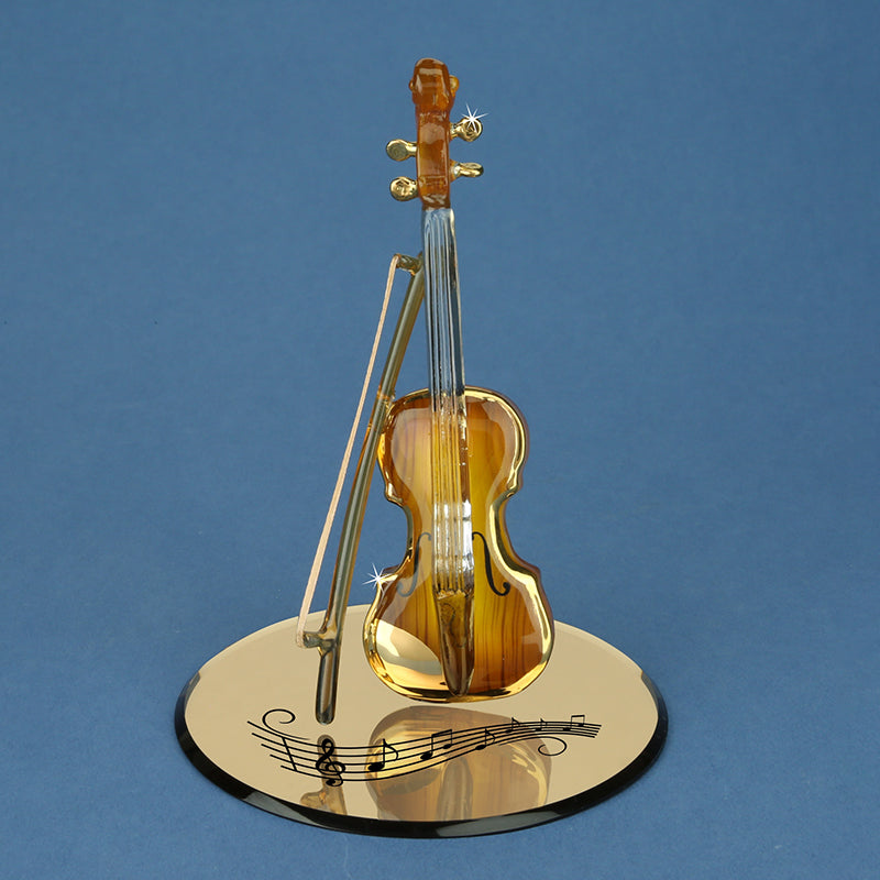 Brown faux-wood glass violin on a mirror with gold accents