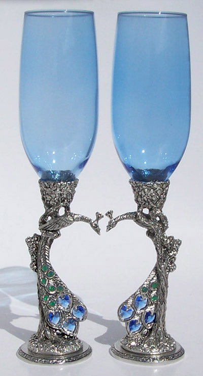 two royal blue wedding peacock heart flutes nestling each other