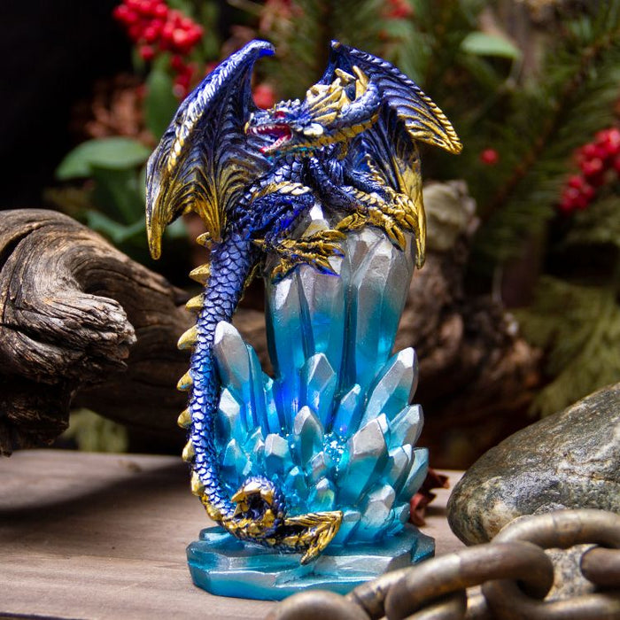 Purple and gold dragon on crystals displayed on a wood table with forest accents