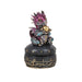 A purple and blue dragon holds a golden egg on top of this black and gold egg timer