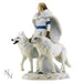 Two white wolves and a woman in ivory and blue standing in the snow, shown from the side