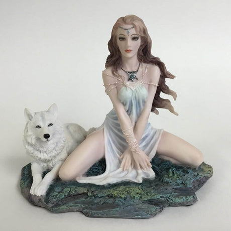 Figurine of brown haired elf in pale dress sitting with a white wolf