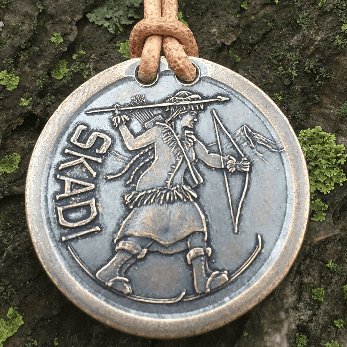 Necklace on leather cord of Norse goddess Skadi on skis with bow