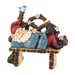 Solar garden ornament of gnome napping with light up bluebird on a wooden bench