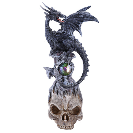 Black dragon snarling, perched on stone with jewel on top of skull