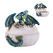 Trinket box shaped like an egg with a blue green dragon hatching
