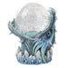 Blue dragon jaws grasping a glitter filled snowglobe. White and blue crystals on the base