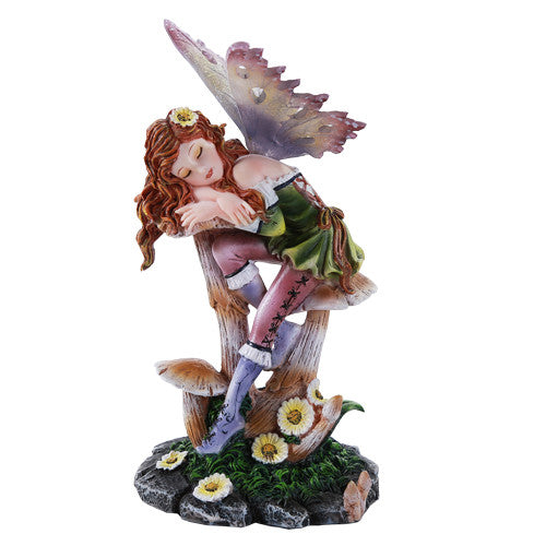 Figurine of fairy sleeping on mushroom. Red hair, flowers, green dress with purple boots