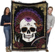 Day of the Dead tapestry blanket shown held up by two adults,