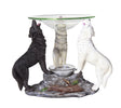 Oil warmer with white, black, and gray wolves holding up glass dish, tealight spot underneath