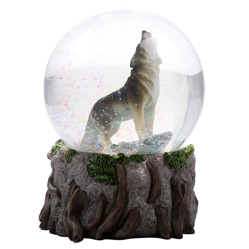 Snowglobe with a howling wolf inside and mossy rock base