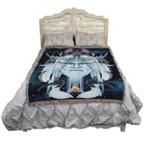 Tapestry blanket with face of an air god, birds, bee, symbols, shown on a bed