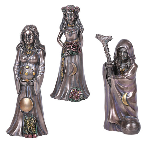 Figurines of the Mother, the Maiden, and the Crone with flowers and moon adornments