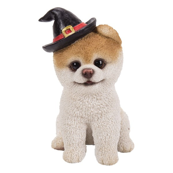 Puppy dog figurine, white and brown textured fur wearing black witch hat with buckle