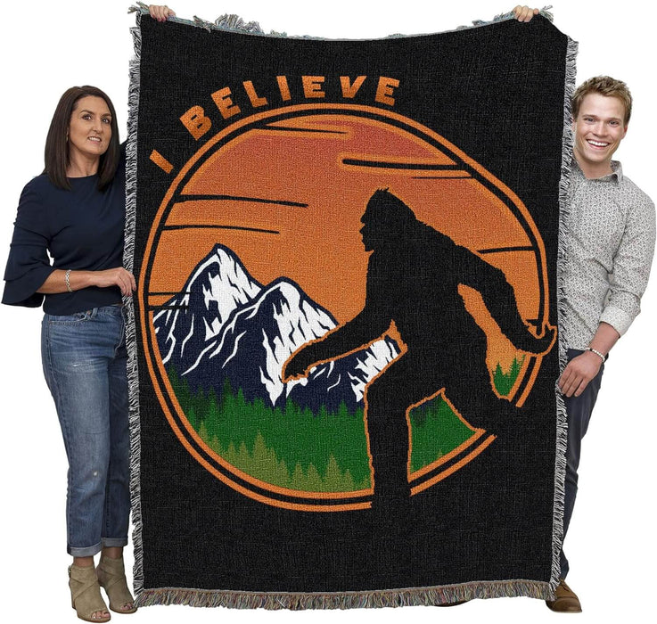 Bigfoot tapestry blanket held by two adults to show large size