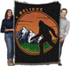Bigfoot tapestry blanket held by two adults to show large size