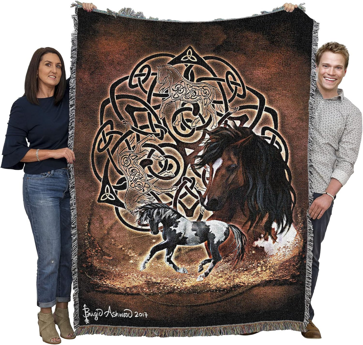 Tapestry blanket with Celtic knotwork and horses, held by two adults