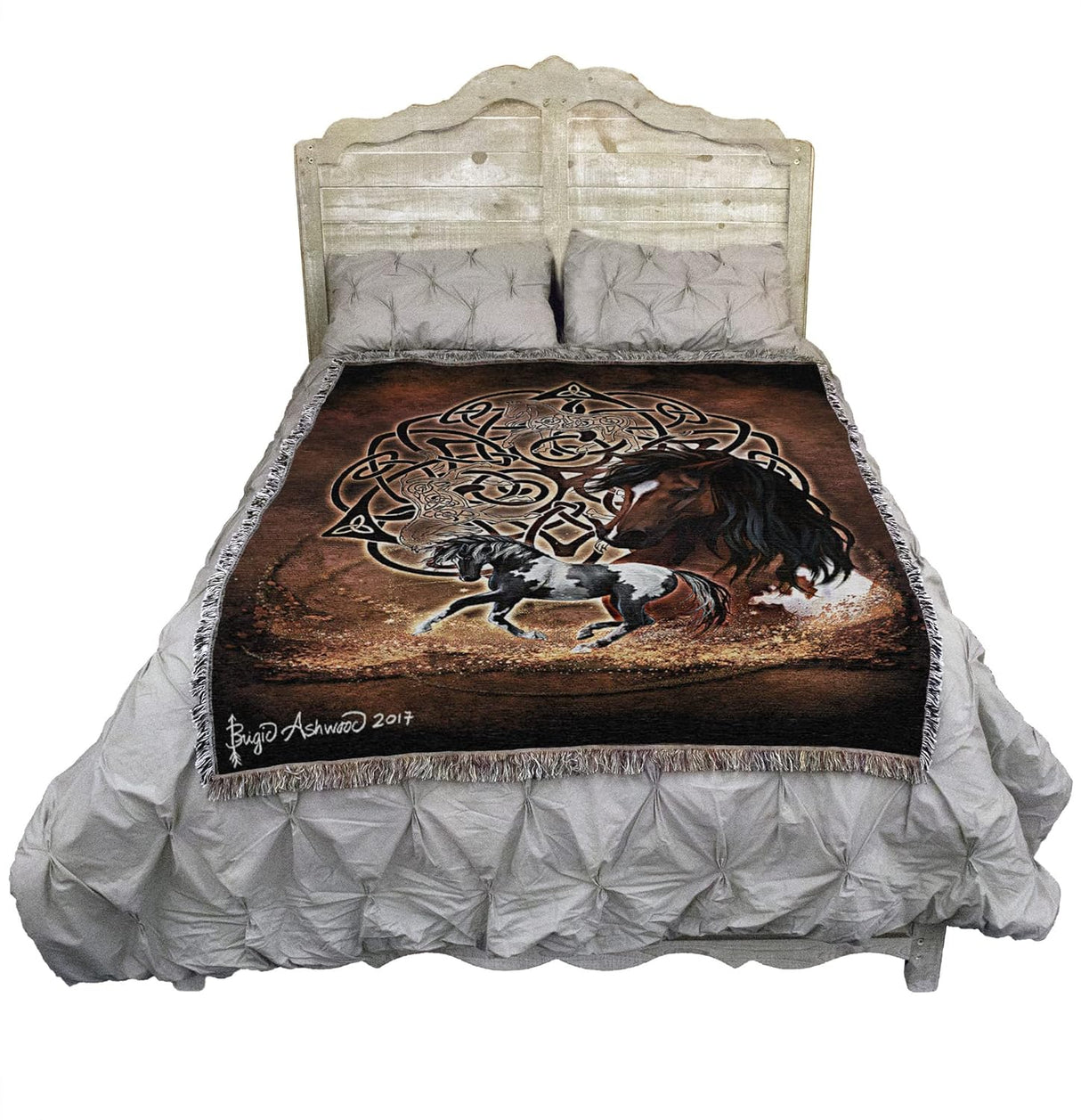 Tapestry blanket with Celtic knotwork and horses, shown on a bed