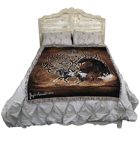 Tapestry blanket with Celtic knotwork and horses, shown on a bed