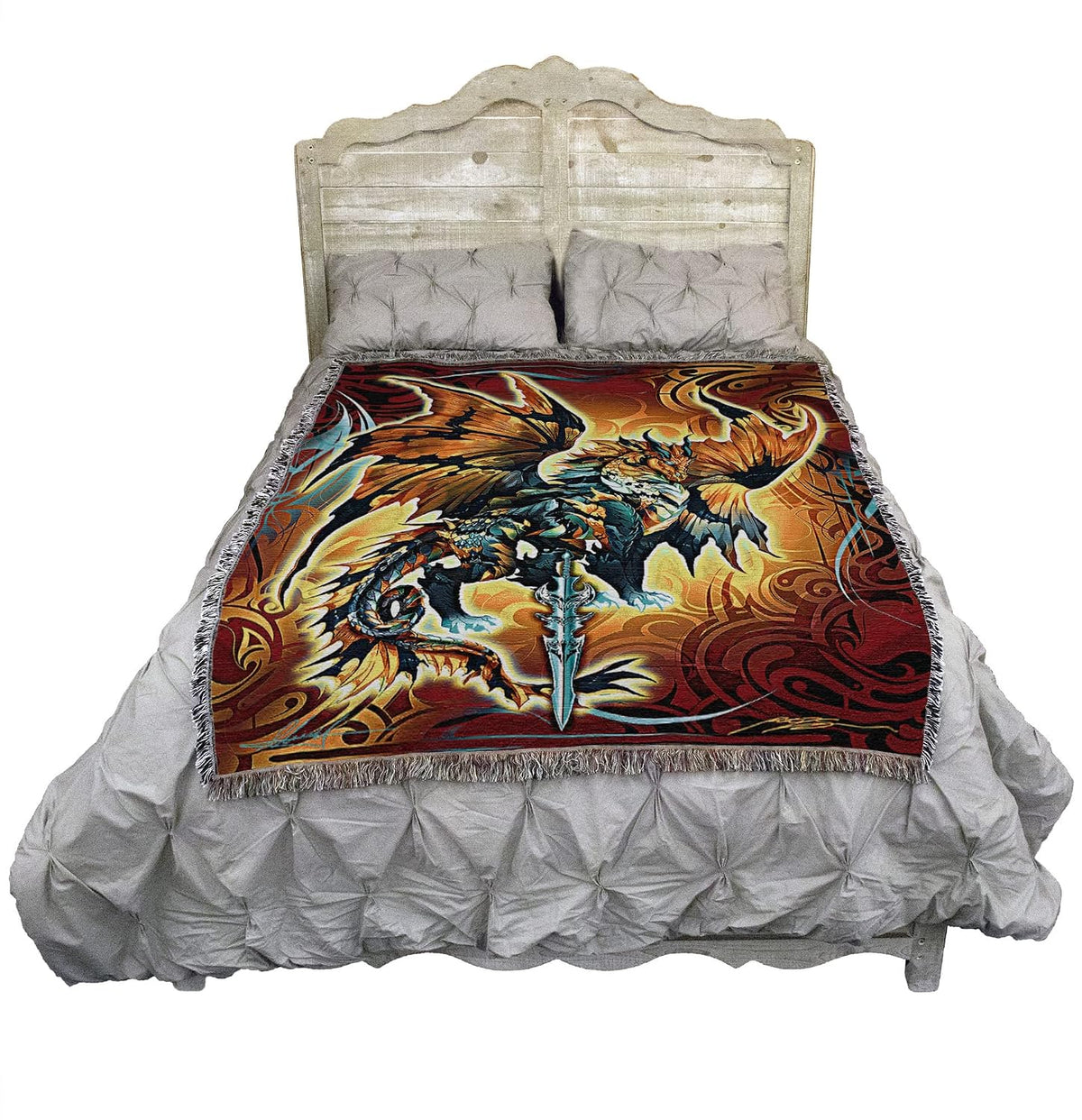Tapestry blanket with dragon and sword. Dragon is done in shades of bronze, brown, black, blue, white, gray. Tribal designs surround it. Shown on a bed