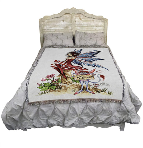 Tapestry blanket by Amy Brown, fairy in red on mushroom with gnome holding sign that says "The Brat", shown on bed