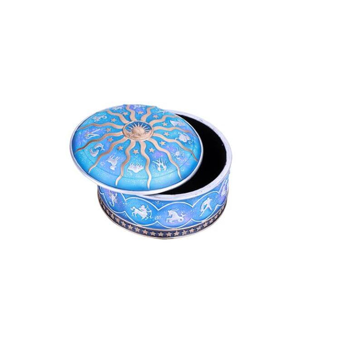 Round blue trinket box with gold sun and stars and silver Zodiac signs, shown open