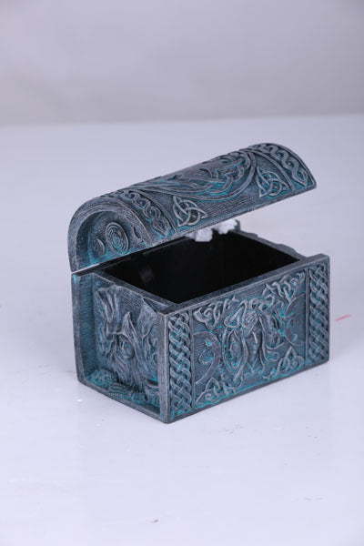 Decorative blue gray box with intricate patterns on a white background