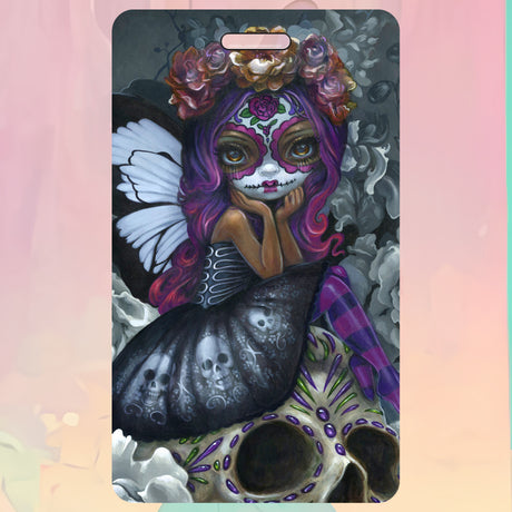 Luggage tag with fairy in face paint sitting on a skull