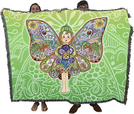 Colorful butterfly fairy design on a green patterned blanket held by two people.