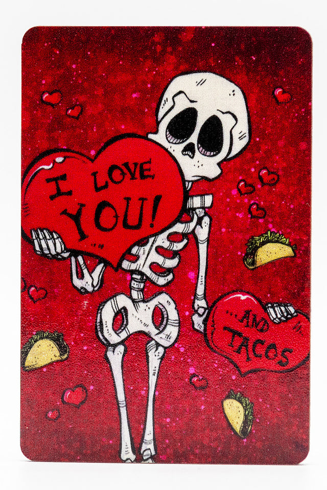 Magnet of a skeleton holding a heart that says "I LOVE YOU!" and in the background are tacos and another heart that says "...AND TACOS"