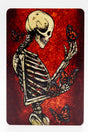 Magnet of a skeleton contemplating and surrounded by monarch butterflies on a red background