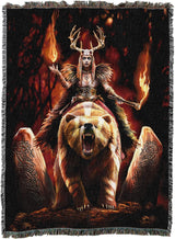 Woven blanket with a fantasy design of a warrior woman on a bear with flames and stone carvings.