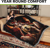 Woman sitting on a couch with a decorative blanket featuring a bear and warrior woman design, with text 'Year Round Comfort' at the top.
