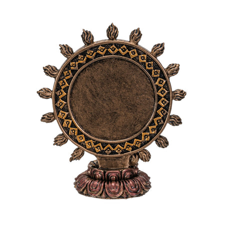 Decorative bronze wheel with intricate designs on a white background