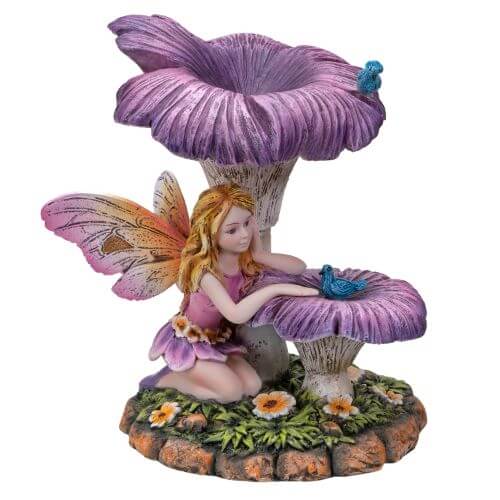 Blond pixie with pink and yellow wings sits under purple flowers with two blue birds