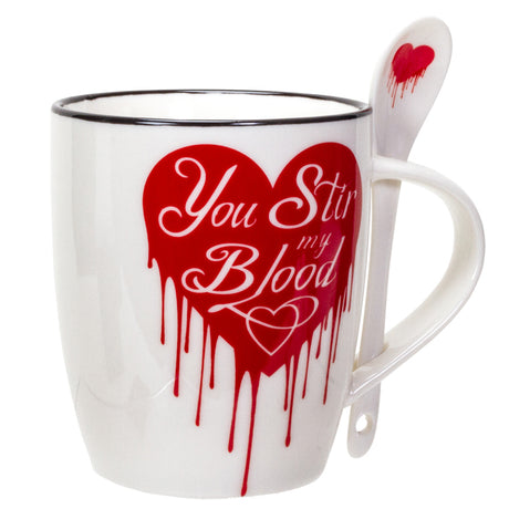 White mug with red dripping heart design and spoon, text on mug reads "You Stir my Blood"