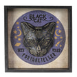 Framed artwork of a black cat with text 'Black Cat Sees Fortuneteller Tells' on a purple circle background.