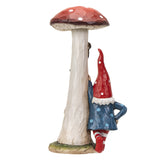 Figurine of mushroom house with windows and gnome in blue and red