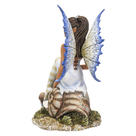 Fairy figurine by Amy Brown, pixie sitting on snail shell, blue tinged wings and striped stockings, back view