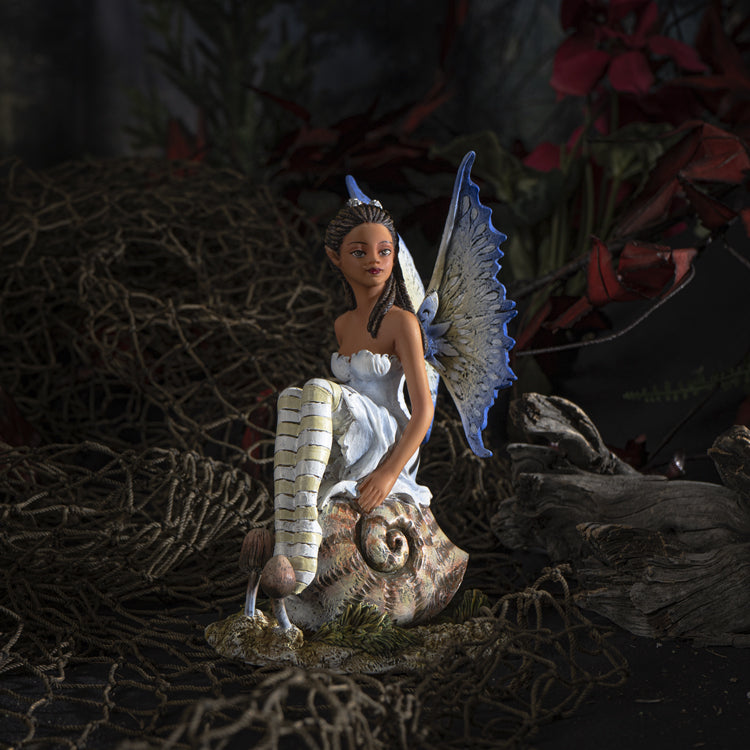 Fairy figurine by Amy Brown, pixie sitting on snail shell, blue tinged wings and striped stockings