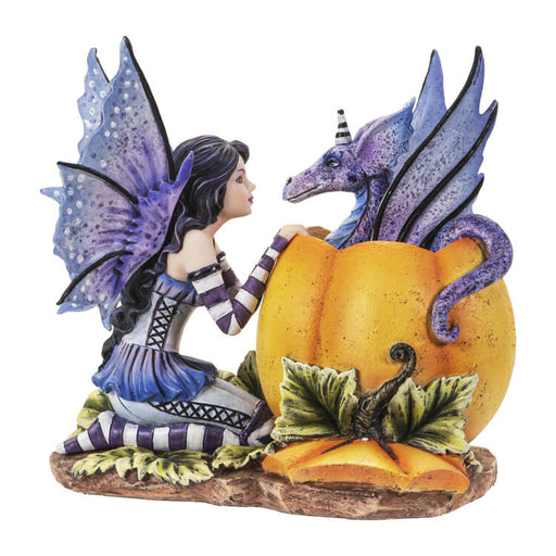 Dark haired fairy with purple wings and dress and striped sleeves & Stockings kneels in front of a pumpkin with a periwinkle dragon popping out