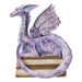 Figurine of a pale purple dragon perched on two books