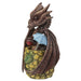 Mai Tai dragon  with brown scales sitting in pineapple holding a cherry, with a blue drink umbrella