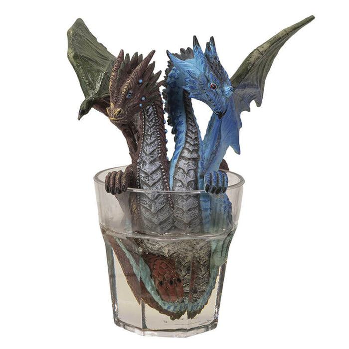 Two headed gin & tonic dragon with blue and brown heads, sitting in glass of clear resin drink