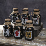 Set of six black bottles with cork lids and hazard symbol labels 